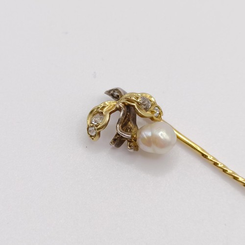 613 - A late 19th/early 20th century yellow metal, diamond and cultured pearl stick pin, in the form of a ... 