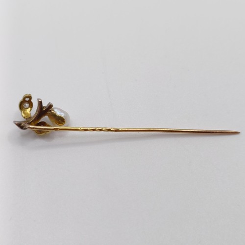 613 - A late 19th/early 20th century yellow metal, diamond and cultured pearl stick pin, in the form of a ... 