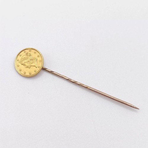 610 - A yellow metal stick pin, set with an American coin  Provenance:  From a single owner collection of ... 