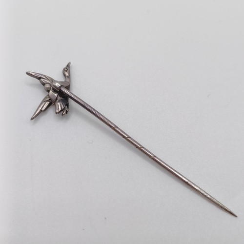 609 - A late 19th/early 20th century silver coloured metal and paste set stick pin, in the form of a goose... 