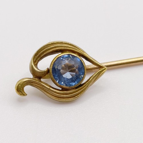 607 - An early 20th century yellow coloured metal and aquamarine stick pin   Provenance:  From a single ow... 