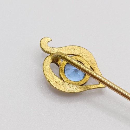 607 - An early 20th century yellow coloured metal and aquamarine stick pin   Provenance:  From a single ow... 