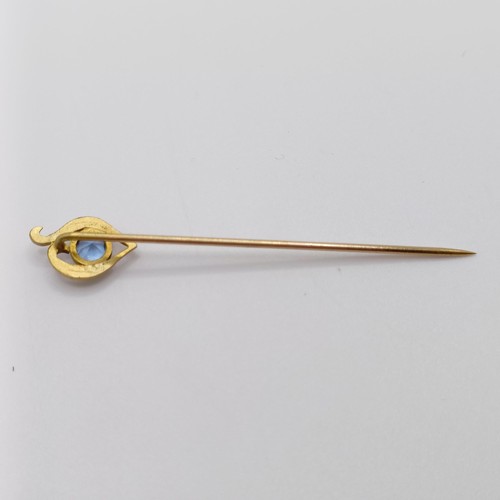 607 - An early 20th century yellow coloured metal and aquamarine stick pin   Provenance:  From a single ow... 