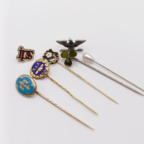 605 - A yellow metal stick pin, four other stick pins, and two pins (7)  Provenance:  From a single owner ... 