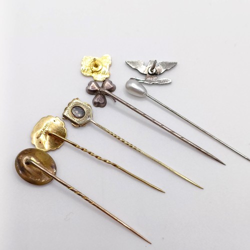 605 - A yellow metal stick pin, four other stick pins, and two pins (7)  Provenance:  From a single owner ... 