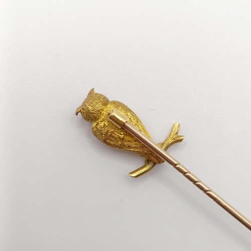 543 - A late 19th/early 20th century yellow metal stick pin, in the form of an owl perched on a twig Prove... 