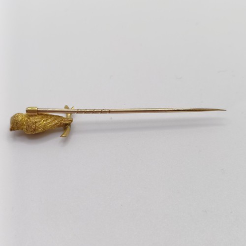 543 - A late 19th/early 20th century yellow metal stick pin, in the form of an owl perched on a twig Prove... 