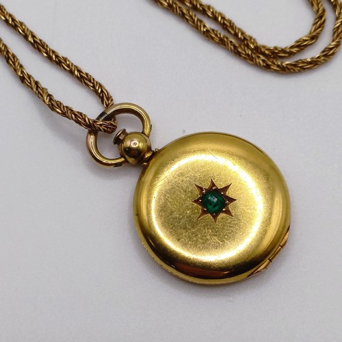 668 - A 9ct gold and green stone locket, on a yellow metal chain