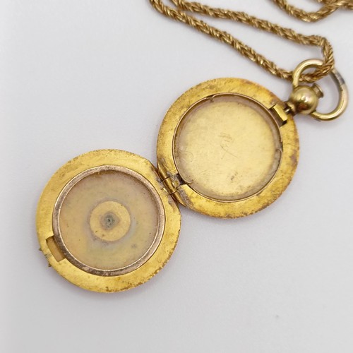 668 - A 9ct gold and green stone locket, on a yellow metal chain