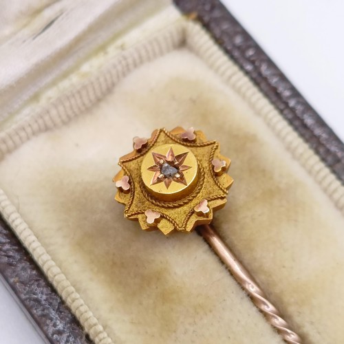 793 - A late 19th/early 20th century yellow metal and white stone stick pin, in a vintage jewellery box