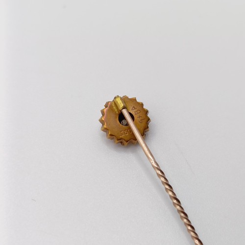 793 - A late 19th/early 20th century yellow metal and white stone stick pin, in a vintage jewellery box