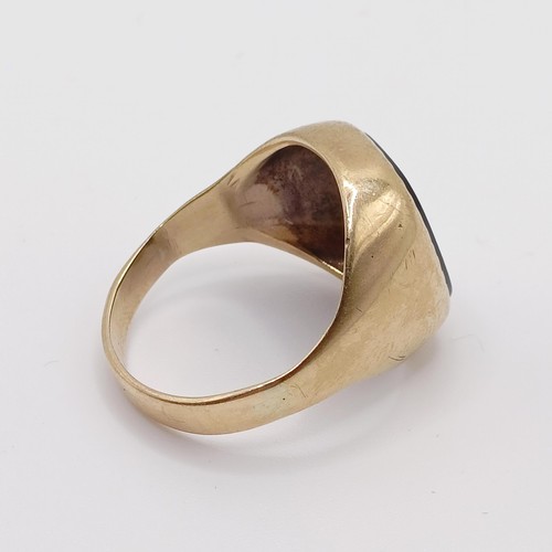 791 - A 9ct gold and black stone signet ring, ring size M