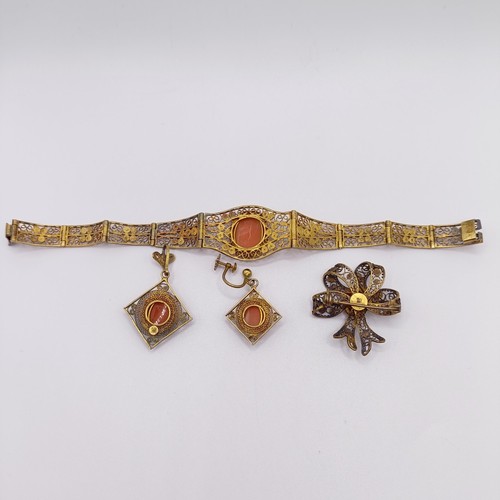 711 - An early 20th century gilt metal and cameo bracelet, a matching brooch, pendant, and a single earrin... 