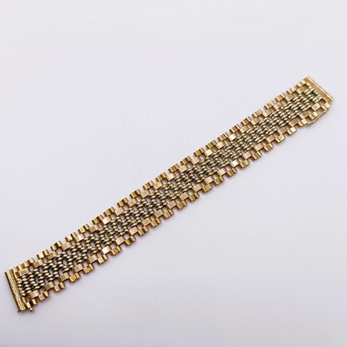 710 - A bi-colured 9ct gold bracelet, 32.5g