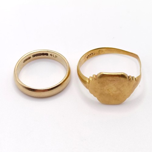 709 - A 9ct gold signet ring, bent, and a 9ct gold wedding band, ring size K, 7.4 g