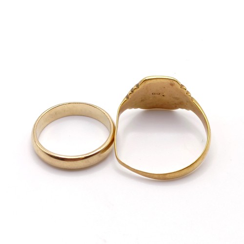 709 - A 9ct gold signet ring, bent, and a 9ct gold wedding band, ring size K, 7.4 g