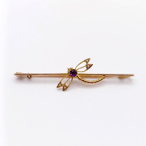 708 - A yellow coloured metal, purple stone and seed pearl bar brooch, in the form of a dragonfly