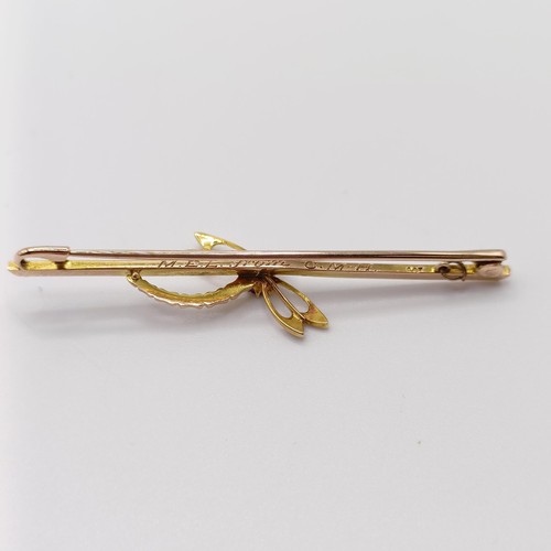 708 - A yellow coloured metal, purple stone and seed pearl bar brooch, in the form of a dragonfly