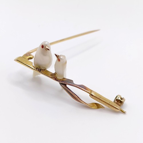 693 - A 1920s yellow coloured metal and mother of pearl bar brooch, in the form of two birds