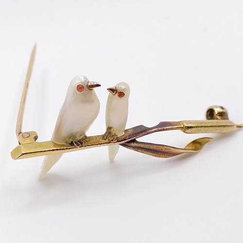 693 - A 1920s yellow coloured metal and mother of pearl bar brooch, in the form of two birds