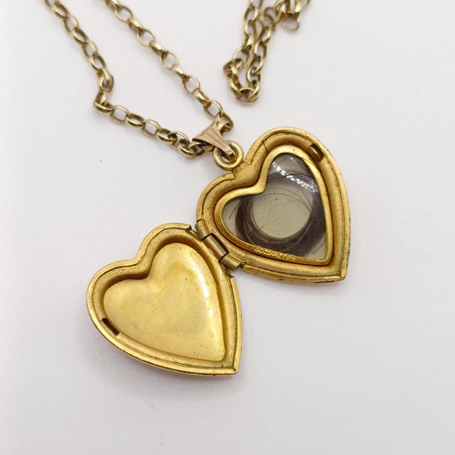 685 - A 9ct heart shaped locket, on a yellow metal chain