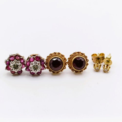 684 - A pair of yellow metal and red stone ear studs, and two other pairs of ear studs