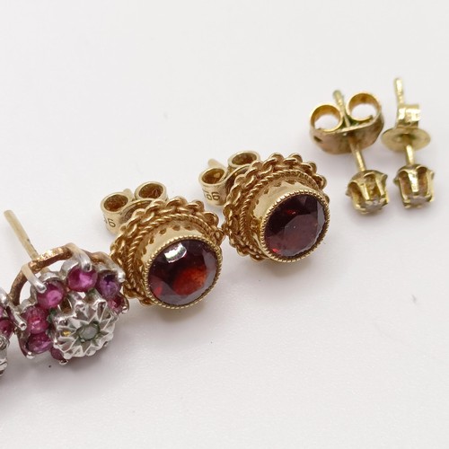 684 - A pair of yellow metal and red stone ear studs, and two other pairs of ear studs