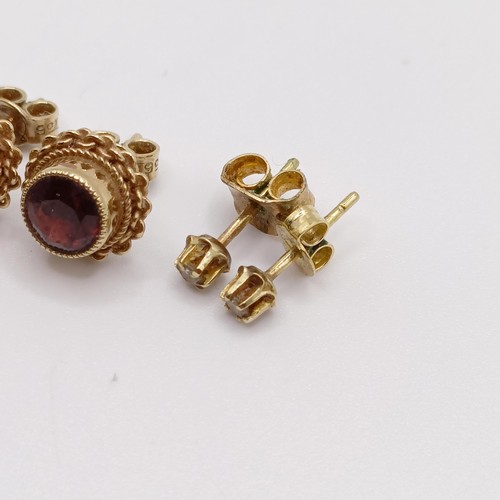 684 - A pair of yellow metal and red stone ear studs, and two other pairs of ear studs