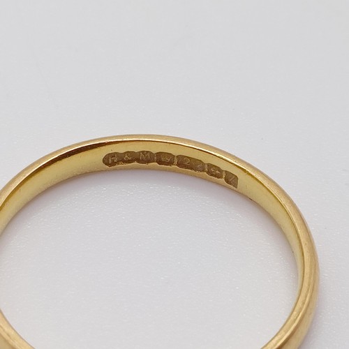 751 - A 22ct gold wedding band, ring size O, 2.5 g, and two other rings