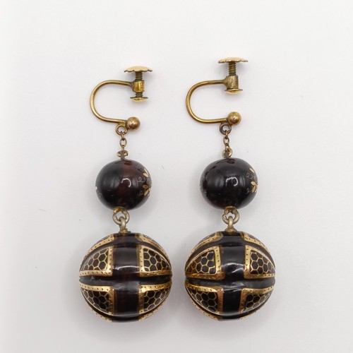 779 - A pair of late Victorian tortoiseshell earrings, with yellow coloured metal inlay