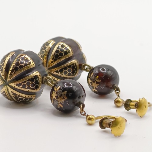 779 - A pair of late Victorian tortoiseshell earrings, with yellow coloured metal inlay