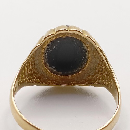 783 - A 9ct gold and black stone signet ring, ring size U, and a gold plated brooch (2)