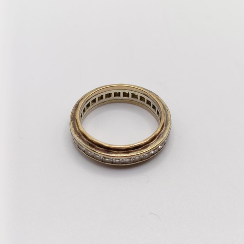 944 - A yellow coloured metal and white stone eternity ring, ring size Q