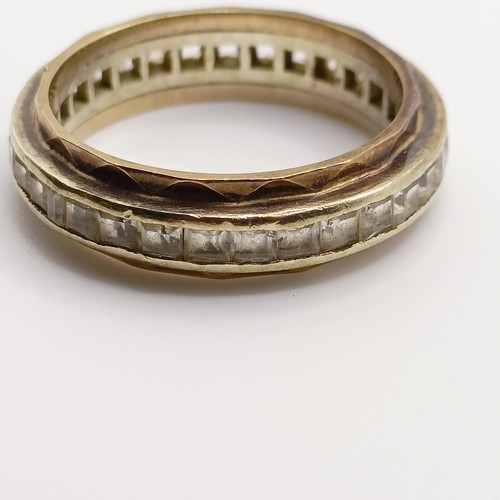 944 - A yellow coloured metal and white stone eternity ring, ring size Q