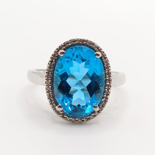 935 - A 9ct white gold and blue stone ring, ring size T, and a 9ct gold and pink stone ring, ring size T