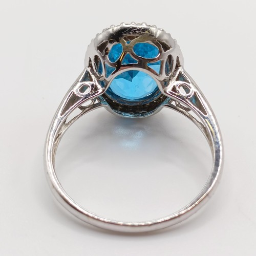 935 - A 9ct white gold and blue stone ring, ring size T, and a 9ct gold and pink stone ring, ring size T