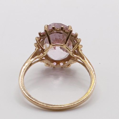 935 - A 9ct white gold and blue stone ring, ring size T, and a 9ct gold and pink stone ring, ring size T