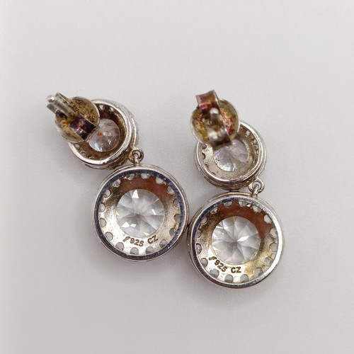 926 - A silver and white stone dress ring, ring size S, two other rings, and two pairs of earrings