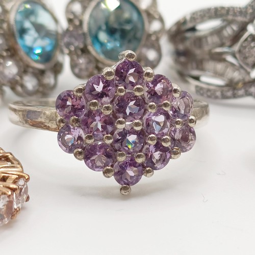 922 - A silver and purple stone dress ring, assorted dress rings, and three pairs of earrings