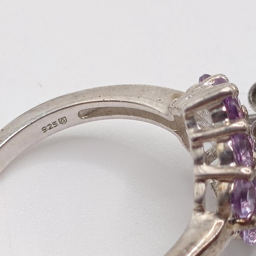 922 - A silver and purple stone dress ring, assorted dress rings, and three pairs of earrings