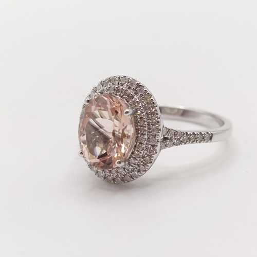 932 - A 14k white gold and pink stone ring