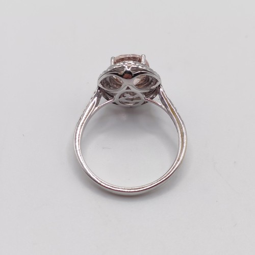 932 - A 14k white gold and pink stone ring