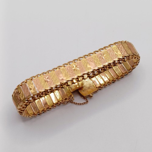 902 - A bi-coloured yellow metal bracelet