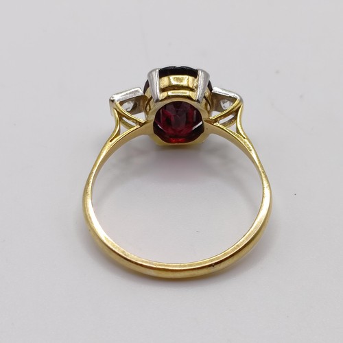 889 - A garnet and diamond three stone ring, ring size U