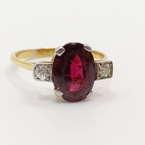 889 - A garnet and diamond three stone ring, ring size U