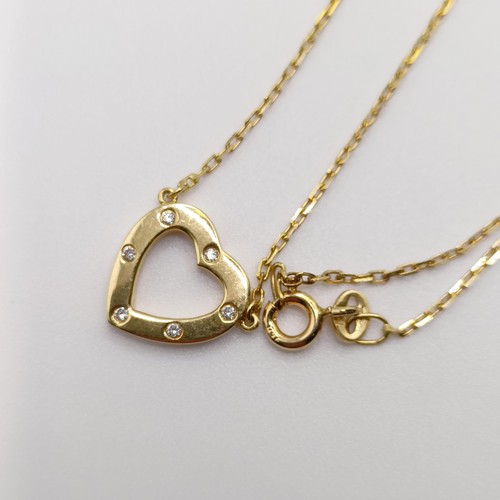 873 - An 18ct gold and diamond heart shaped pendant, on a chain