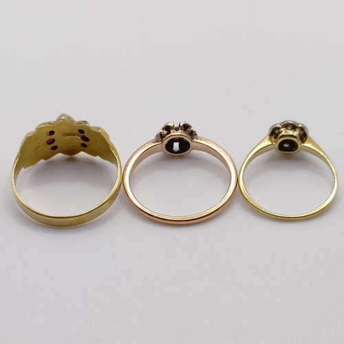 849 - A 9ct gold and red stone ring, ring size N, and two other rings (3)