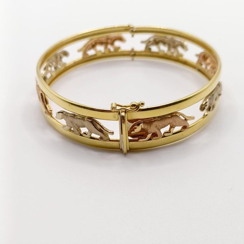 847 - An 18ct tri-colour gold bangle, decorated big cats, 21 g