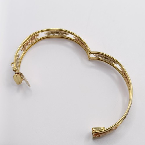 847 - An 18ct tri-colour gold bangle, decorated big cats, 21 g