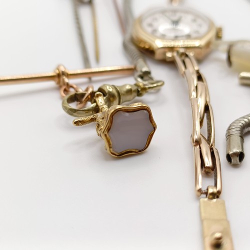 846 - A ladies 9ct gold wristwatch, a charm, a novelty whistle, in the form of an owl, on a silver plated ... 